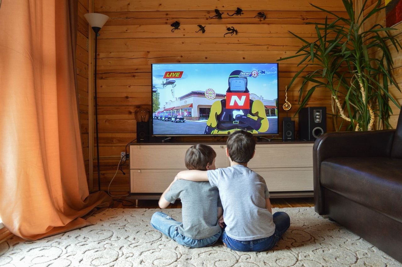 Crafting Captivating Headlines: Your awesome post title goes here Back view of unrecognizable little children in similar casual outfits resting on floor at home and hugging while watching cartoon on TV